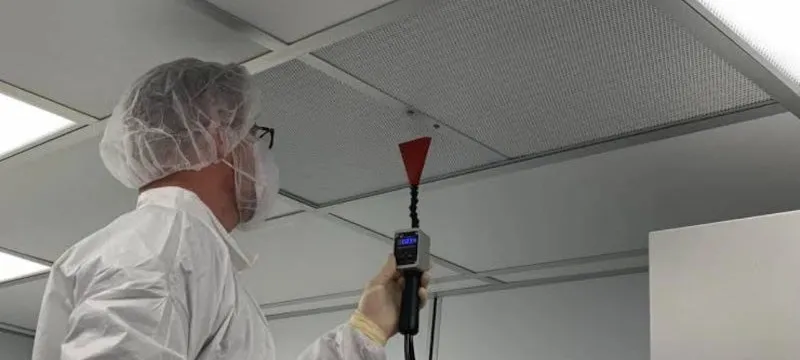 Technician performing a DOP/PAO aerosol scan test on an installed cleanroom HEPA filter