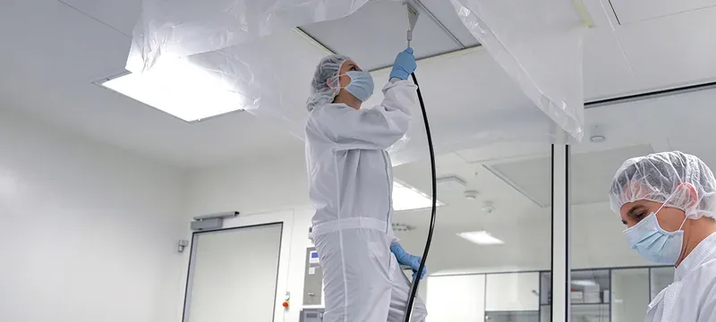 Technician performing HEPA filter leak test cleanroom Technician performing HEPA filter leak test cleanroom