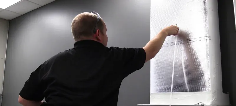 Technician performing pressure drop test on filter